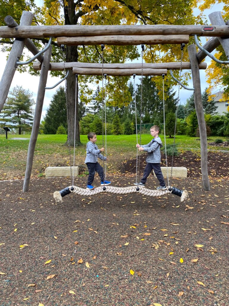 Two boys on a rope climbing structure at Johnston-McVay park.