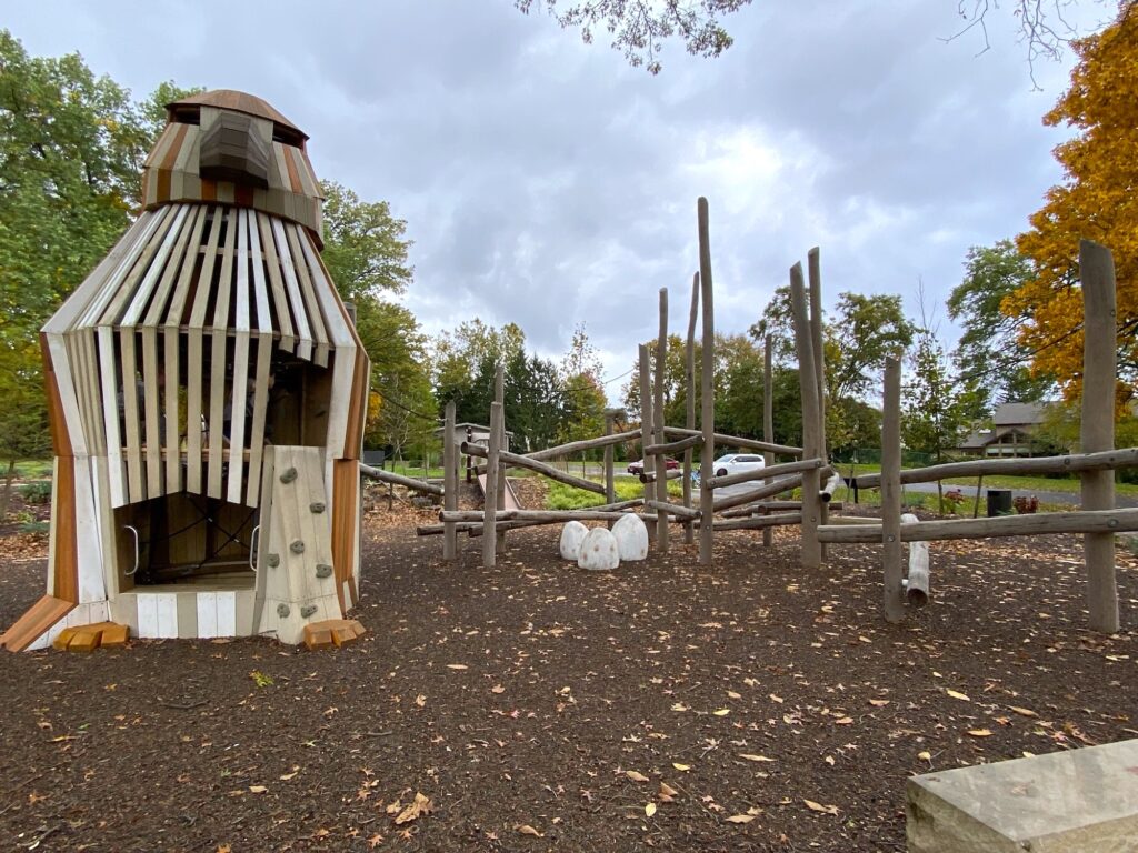 Large wooden hawk and climbing structure in the playground.