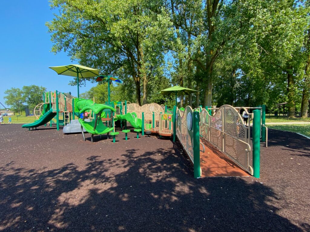 A wide angle view of the main play structure on the playground at Roger A. Reynolds Park.