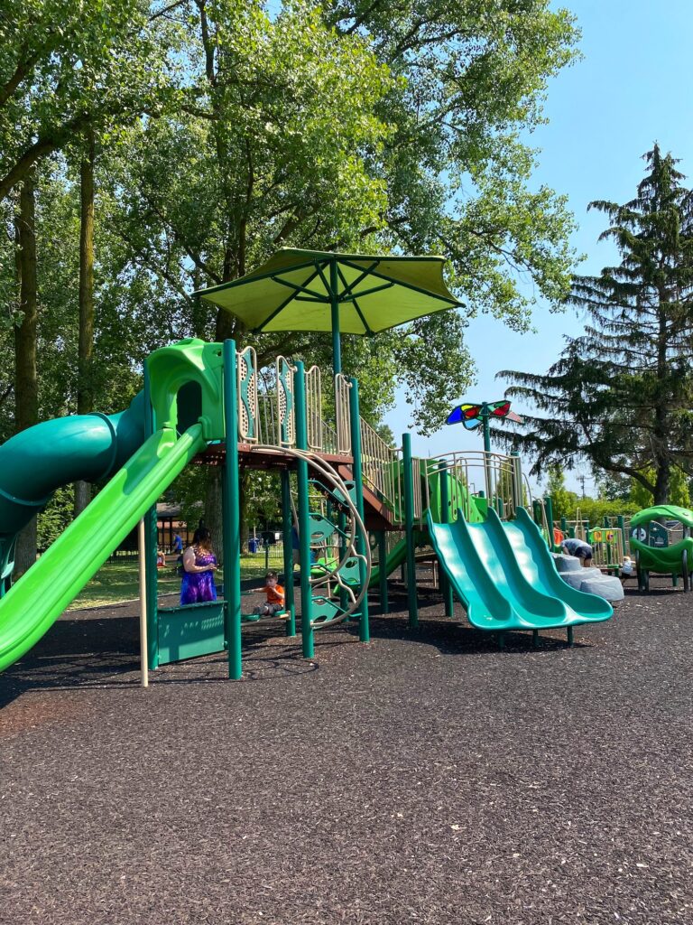 A triple slide and climbing elements at the playground.