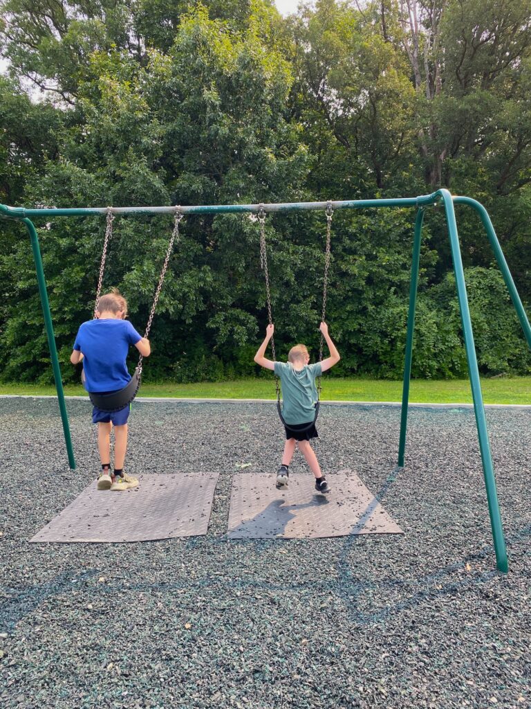 Two boys on regular swings at Henceroth Park.