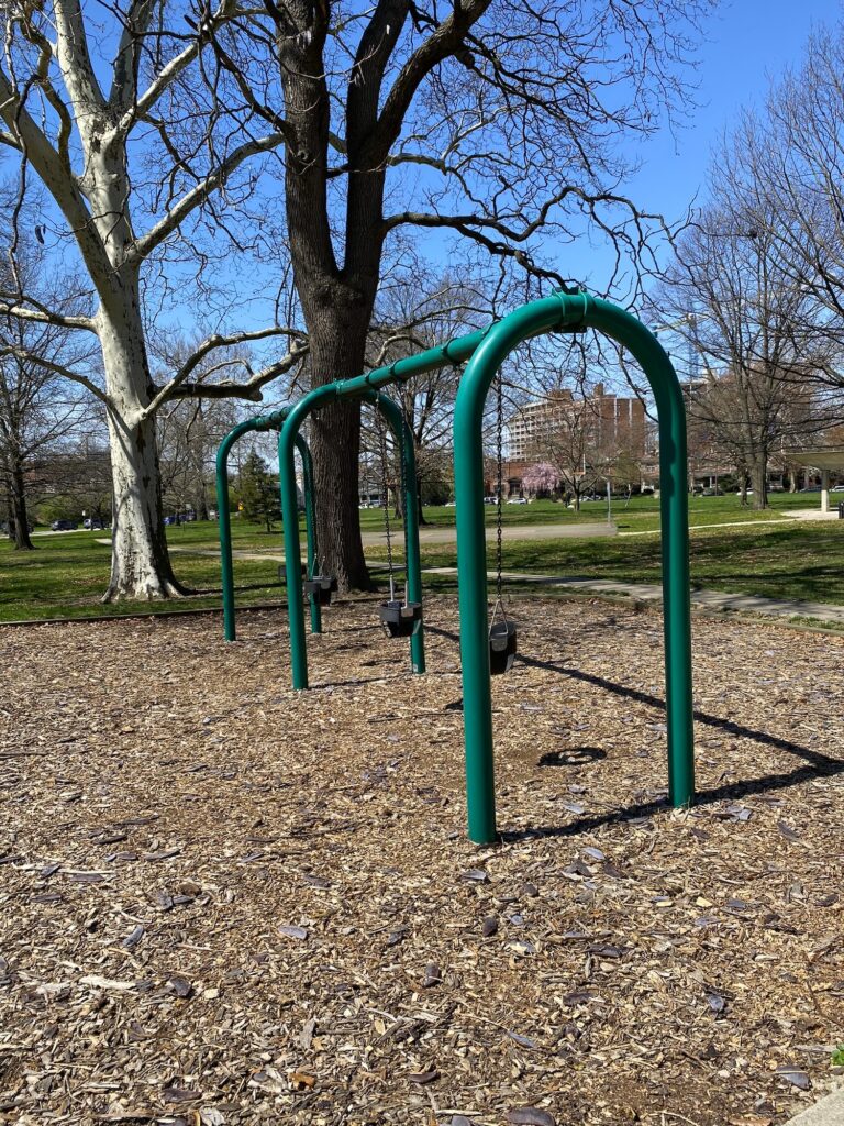 Toddler swings at the park.