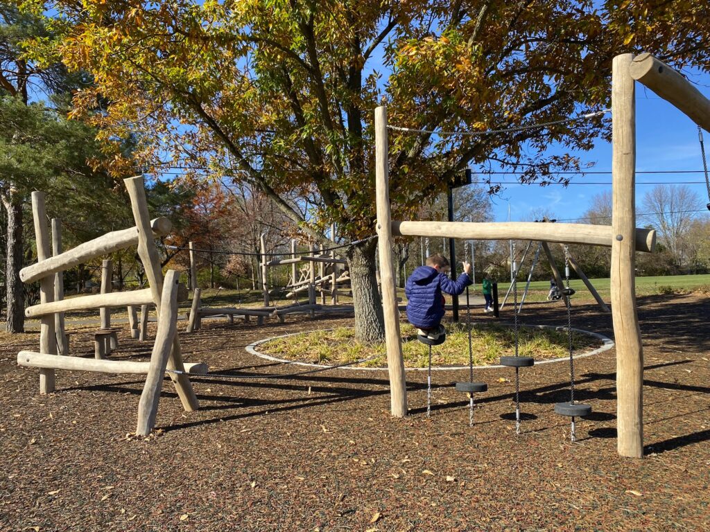 A boy climbing across an obstacle course at McCord Park near Columbus, Ohio.