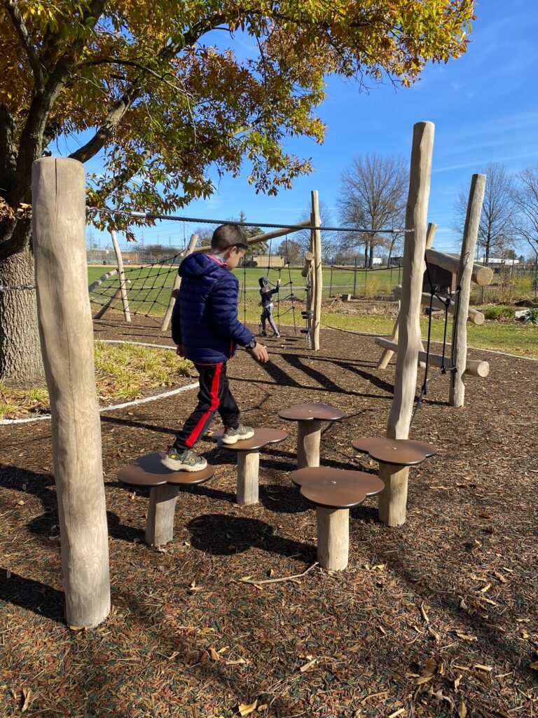 A boy crossing an obstacle course at McCord Park.