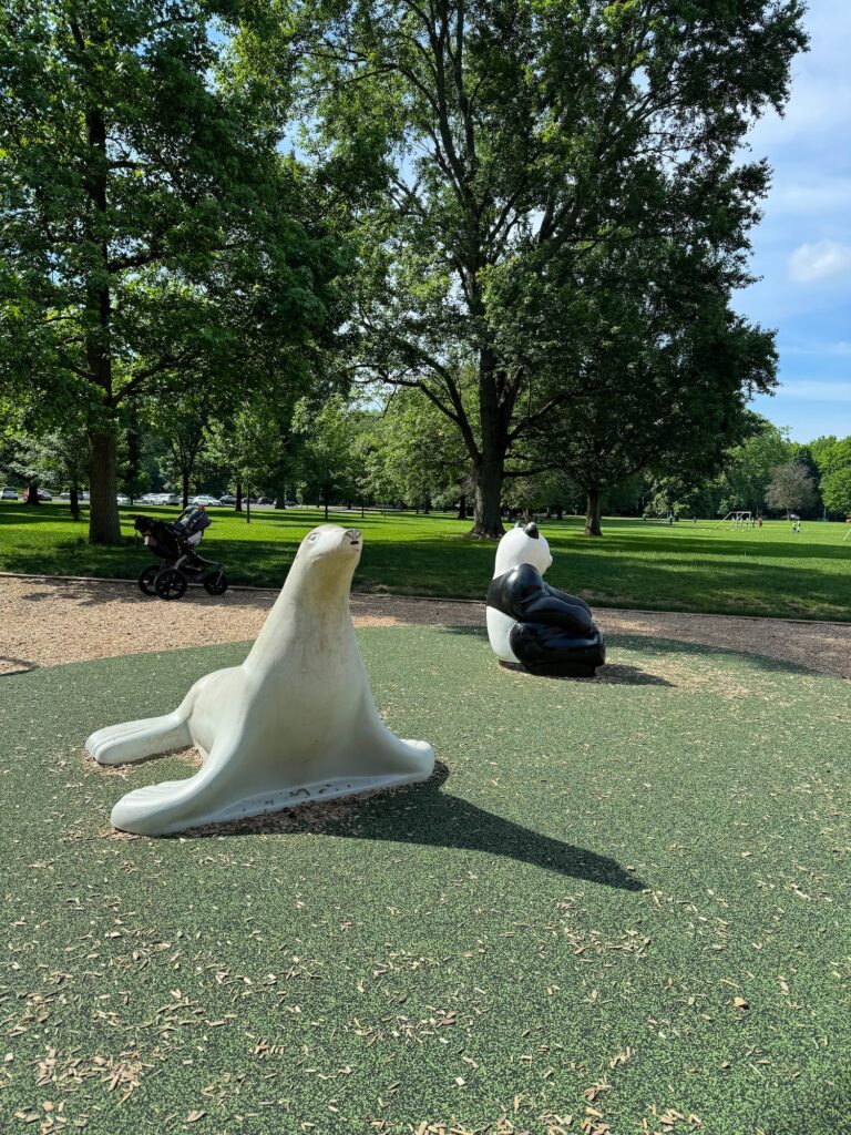 A play seal and panda to climb on in the park.