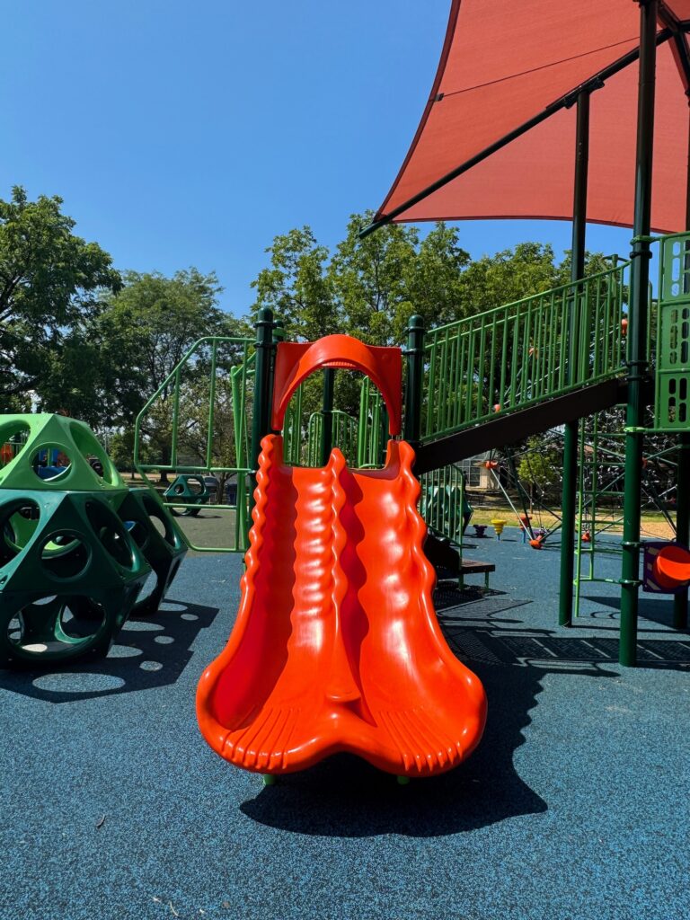 An orange double slide at Thompson Park.