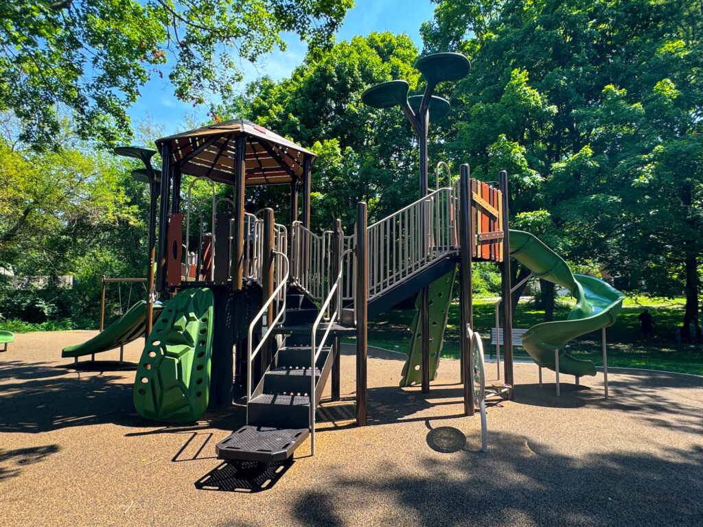 The larger of two play structures in the park.