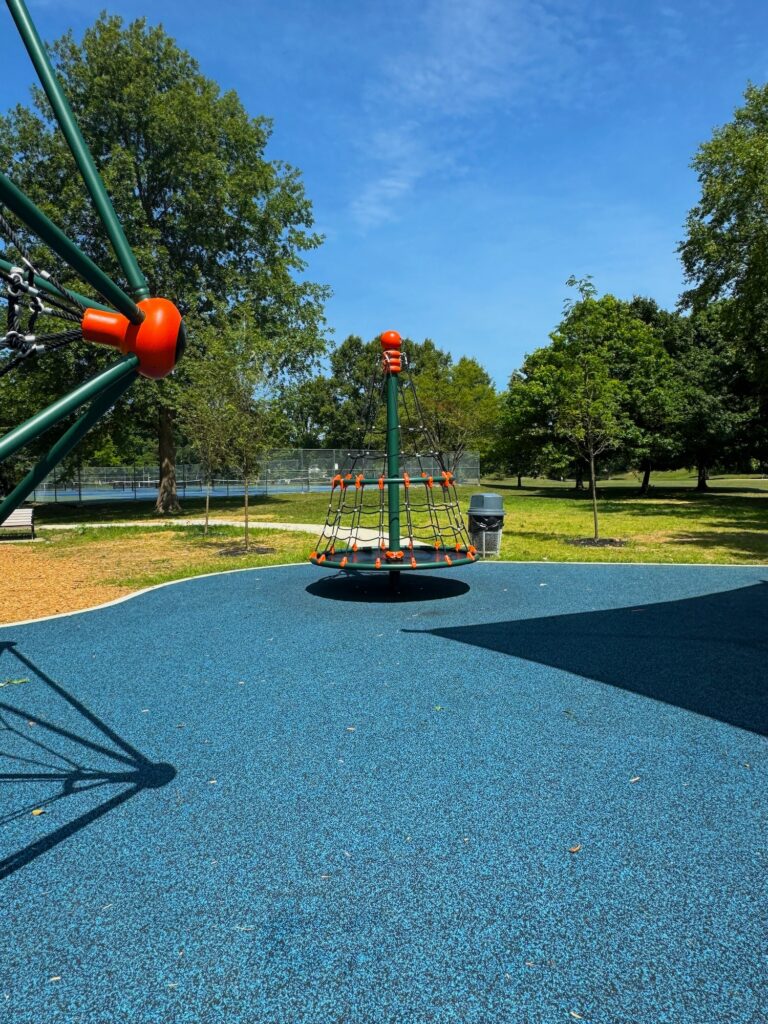 A spinner for multiple kids on the playground at Thompson Park.